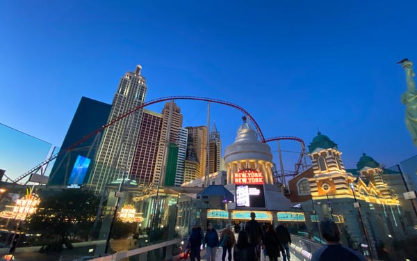 Expat Life Blog Las Vegas - Tourist Ultimate Guide 2021 photo of New York skyscrapers, bridge, and statue of liberty and the huge roller coaster on top of the buildings